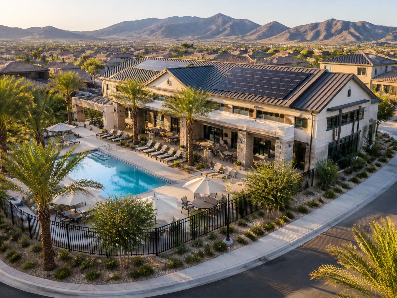 HOA clubhouse and amenity building with a rooftop solar array beside a community pool